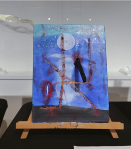 A painting with a blue background, red lines, and a human figure.