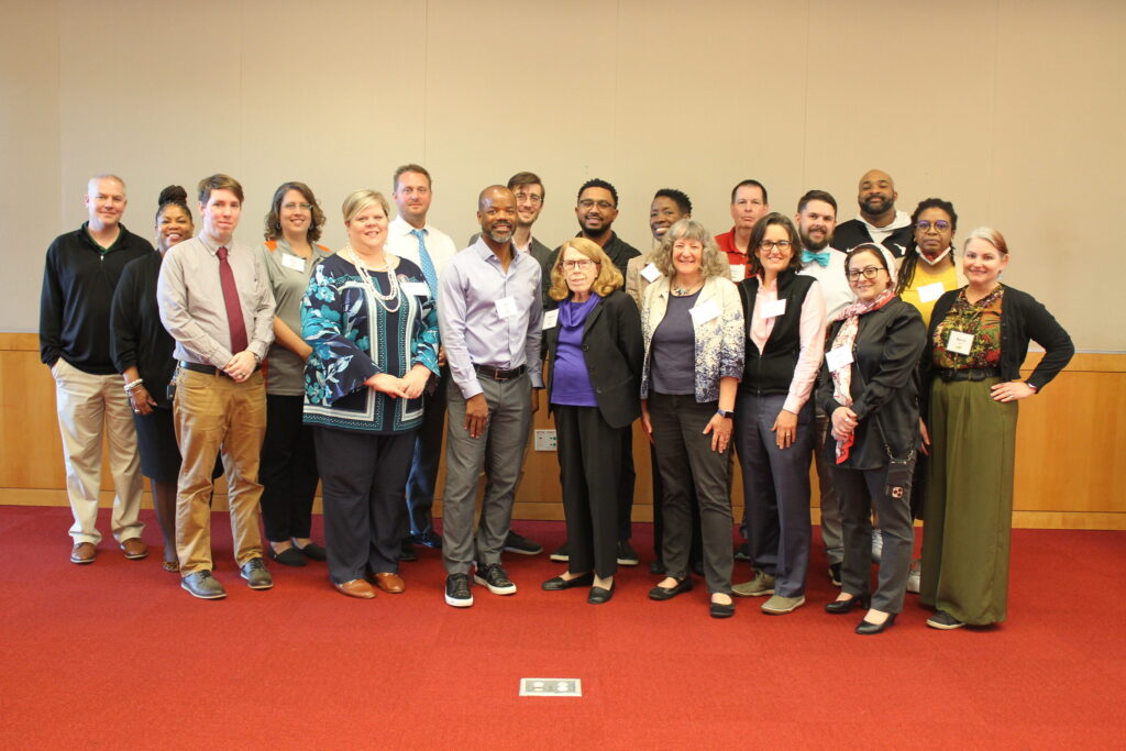 A group of attendees of the CS4NC Convening stand in a group posing for a picture