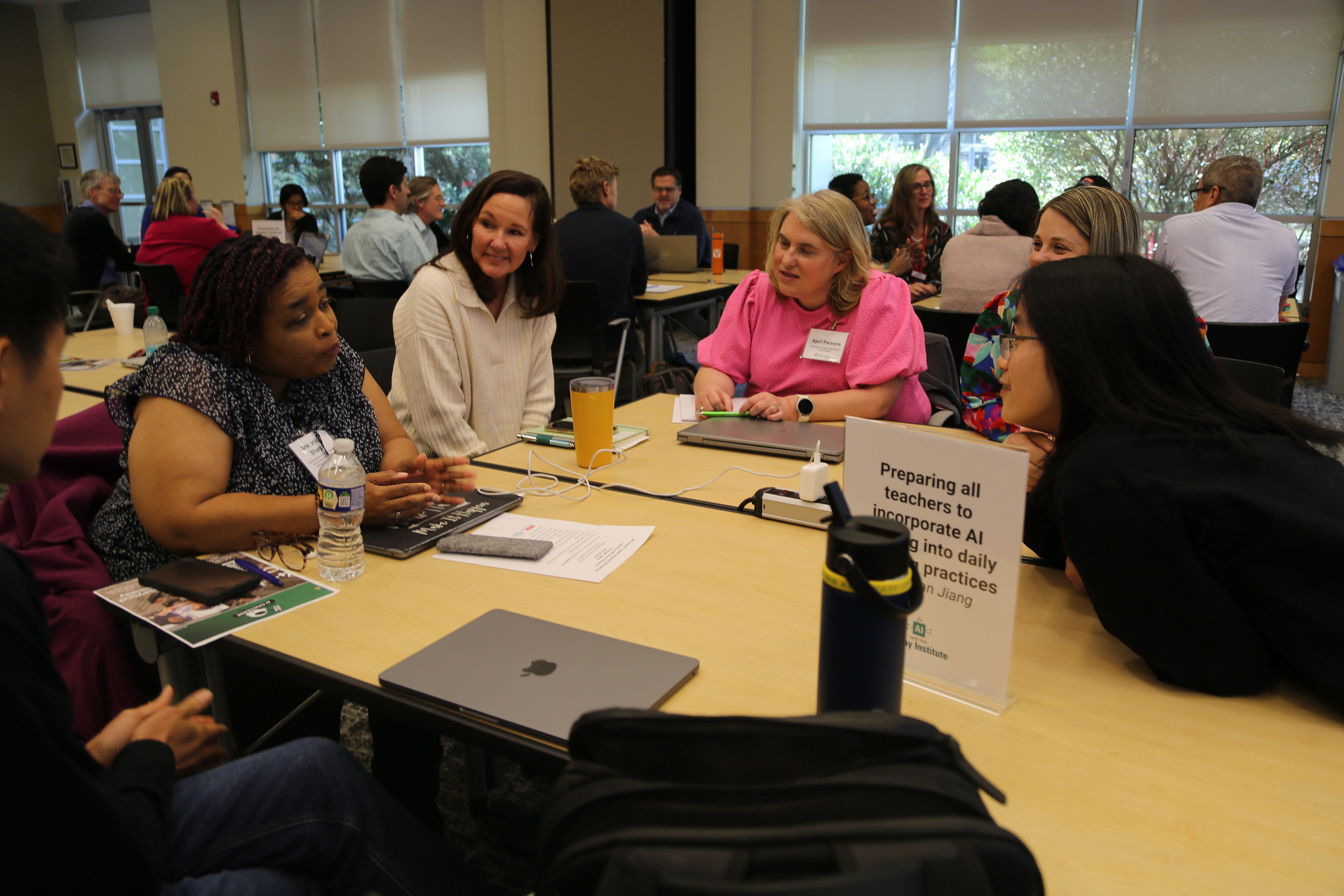 A group of people sit at a table having a conversation