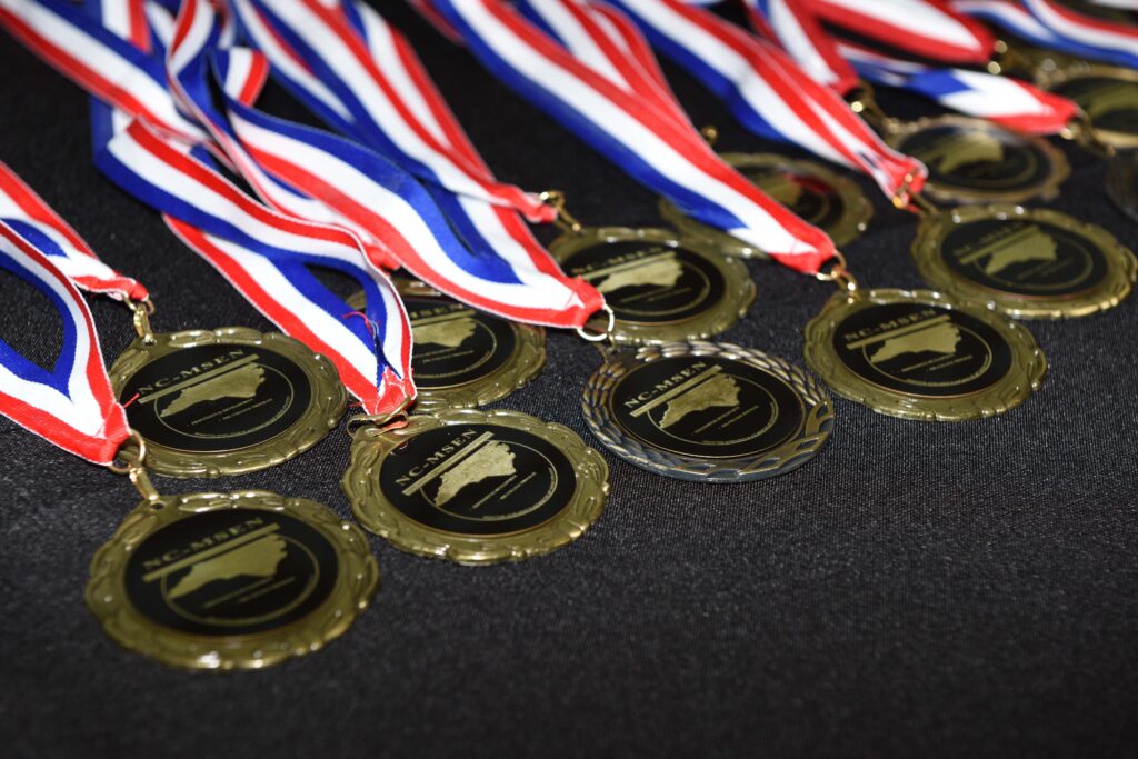 Several medals lie flat on a table for display.