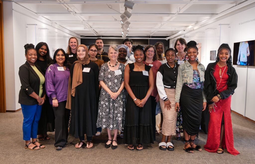 A group of students and teachers stand in a cluster