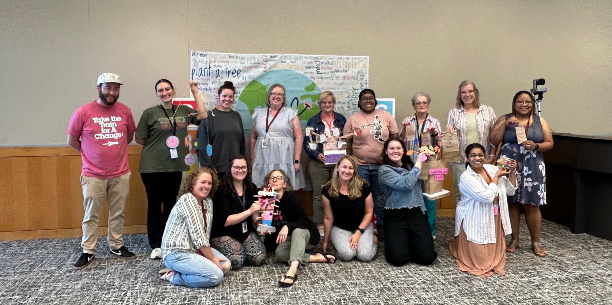 A group of teachers pose with their PBIGlobal projects